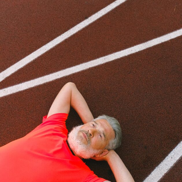 man resting on a race track